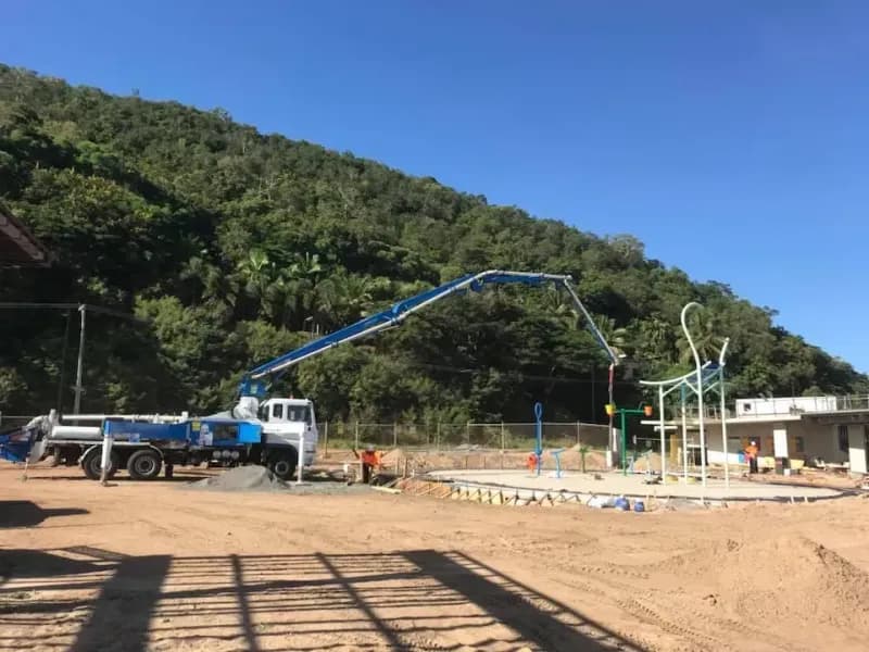 Concrete Pump Truck Pouring Concrete at a Construction Site — Far Northern Concrete Pumping, servicing Trinity Park QLD