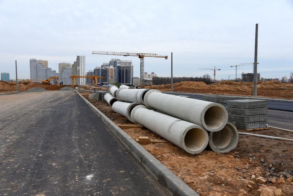 Construction site with concrete pipes, cranes — Far Northern Concrete Pumping in Cape York, QLD