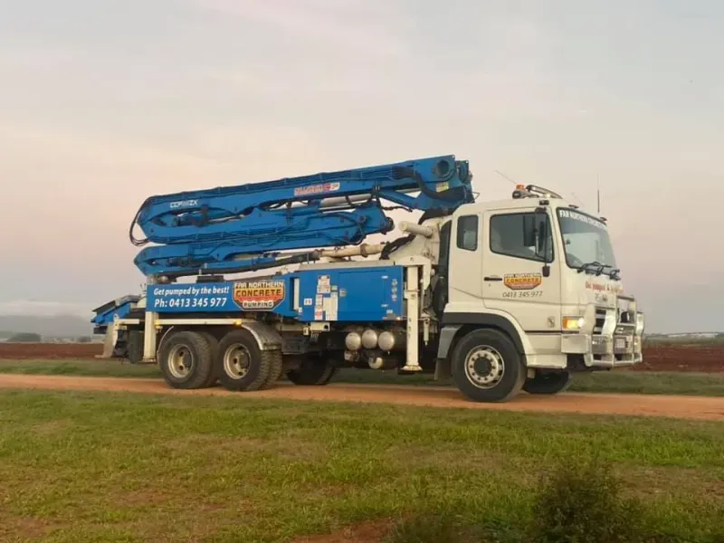 Concrete Pump Truck Driving on a Dirt Road — Far Northern Concrete Pumping in Mareeba, QLD