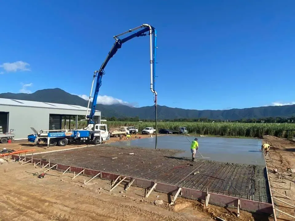 Concrete boom pump extended over a work site